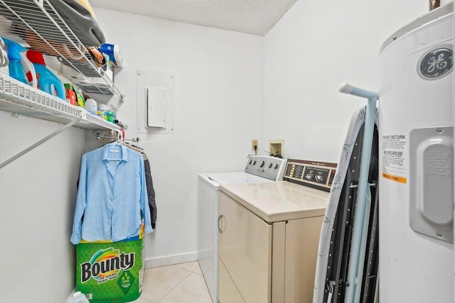 washroom with washing machine and clothes dryer, hookup for a washing machine, a textured ceiling, electric water heater, and light tile floors