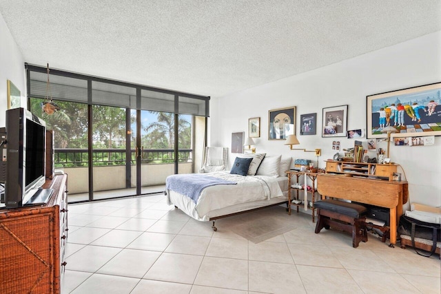 bedroom featuring access to outside, floor to ceiling windows, a textured ceiling, and light tile flooring