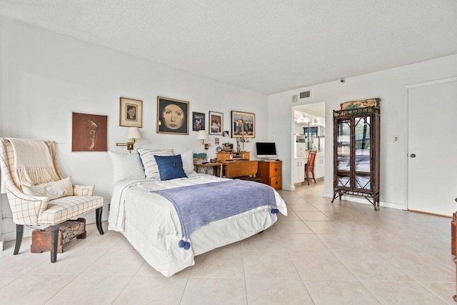 bedroom featuring a textured ceiling and tile floors