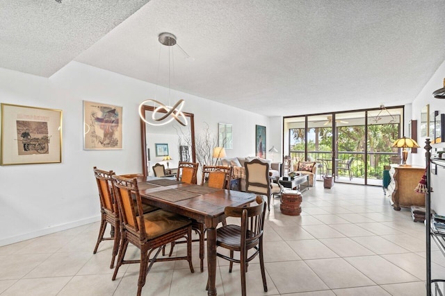 dining area with floor to ceiling windows, a textured ceiling, and light tile floors