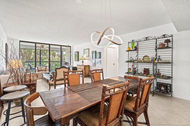 tiled dining space with a textured ceiling