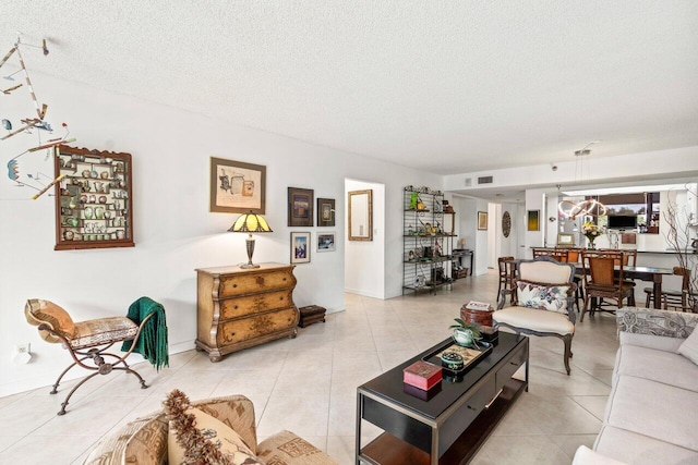 living room featuring a textured ceiling and light tile floors