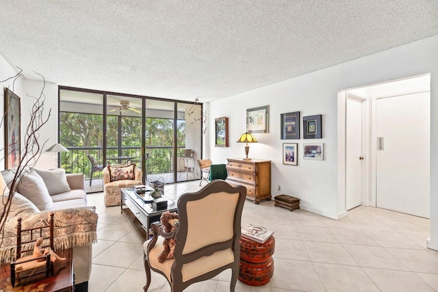 living room featuring a textured ceiling, a wall of windows, and light tile flooring