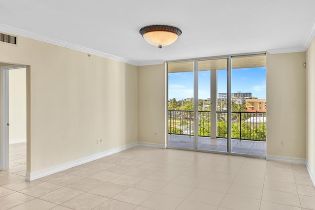 spare room featuring floor to ceiling windows, light tile patterned floors, and ornamental molding