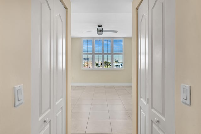 corridor featuring light tile patterned floors