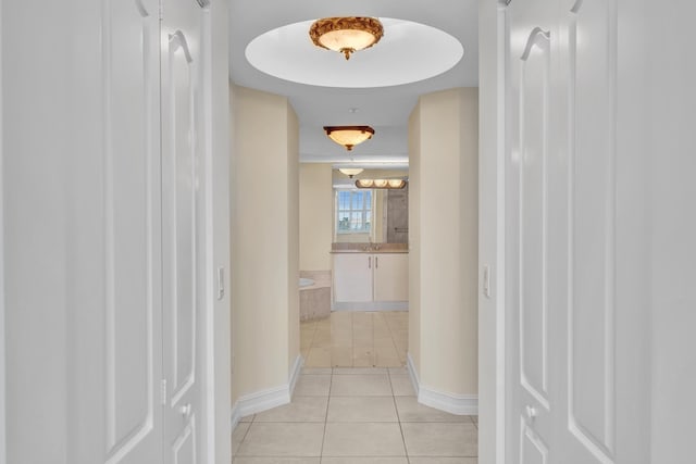 hall featuring light tile patterned floors