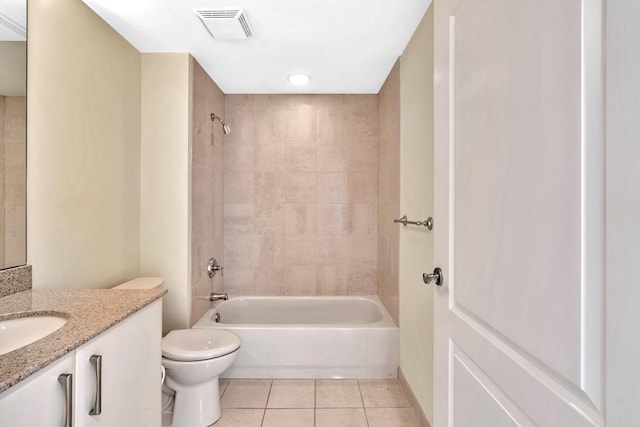 full bathroom with tile patterned flooring, vanity, toilet, and tiled shower / bath combo