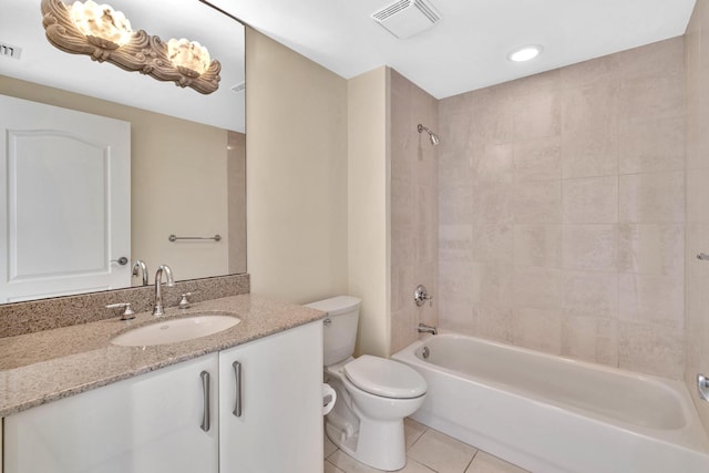 full bathroom with tile patterned flooring, vanity, toilet, and tiled shower / bath