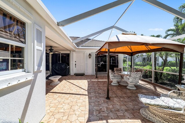 view of patio / terrace featuring a gazebo and glass enclosure