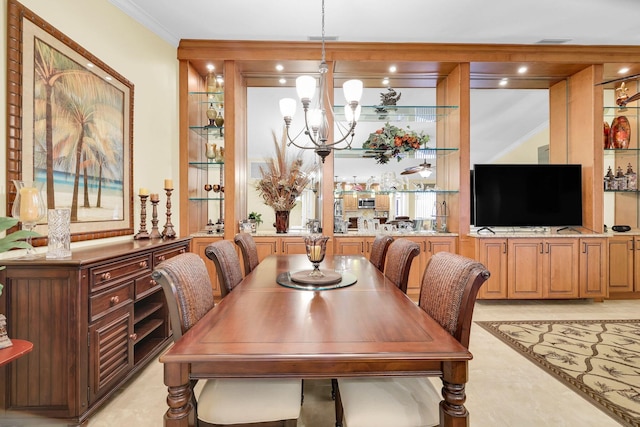 dining area featuring crown molding and an inviting chandelier