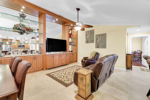 living room featuring ceiling fan, light tile patterned flooring, lofted ceiling, and crown molding