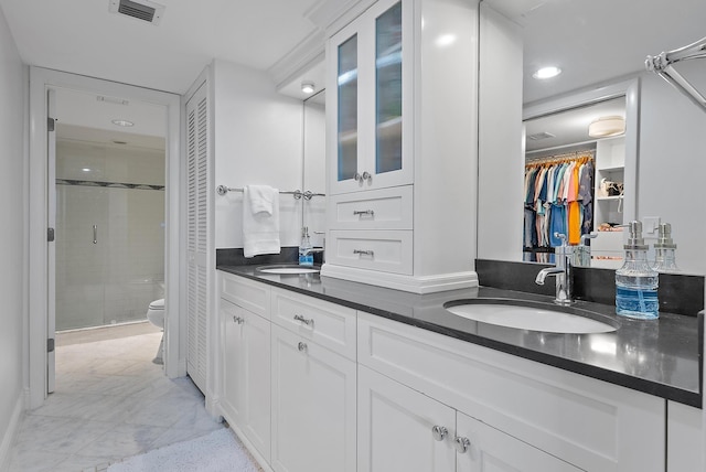 bathroom with vanity, walk in shower, and toilet