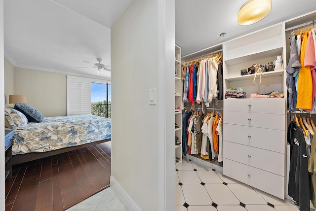 bedroom featuring a closet, ceiling fan, and crown molding