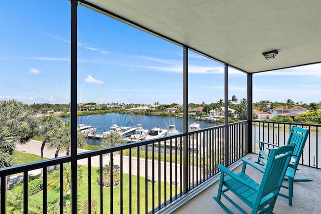 sunroom featuring a water view