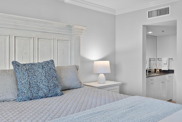 bedroom with ensuite bathroom and crown molding