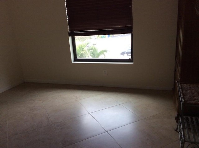 unfurnished room with tile floors