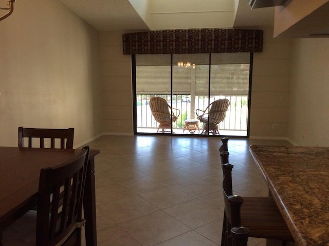 tiled dining space with an inviting chandelier