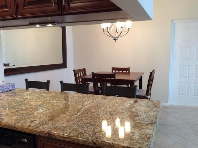 dining room with a notable chandelier and light tile flooring