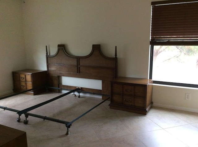 unfurnished bedroom featuring light tile floors