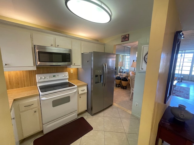 kitchen with appliances with stainless steel finishes and light tile floors