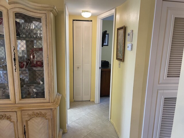 hallway featuring light tile floors