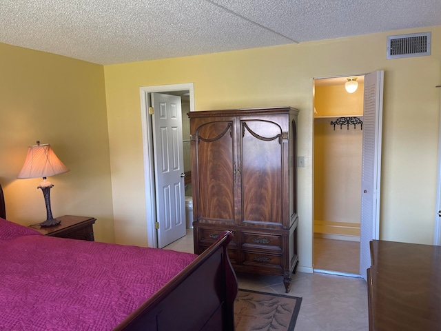 tiled bedroom with a closet