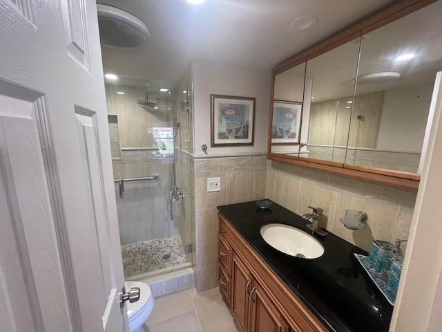 bathroom featuring tile flooring, tile walls, backsplash, toilet, and large vanity