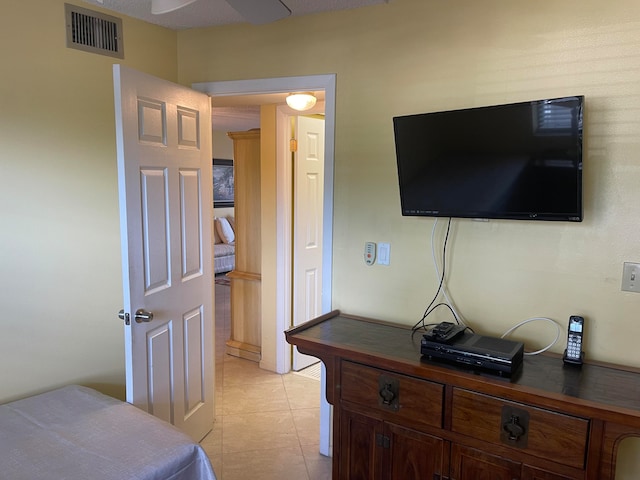 tiled bedroom with ceiling fan