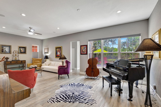 interior space with ceiling fan and light hardwood / wood-style flooring