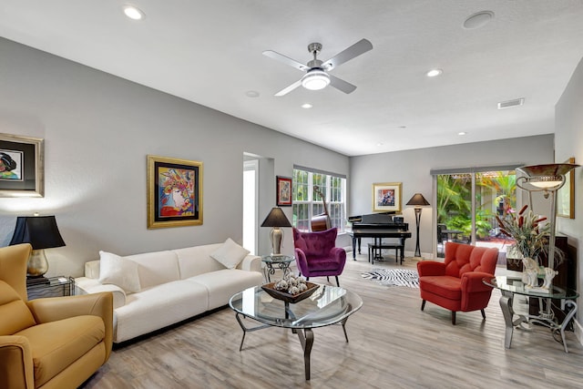 living room with light wood-type flooring and ceiling fan