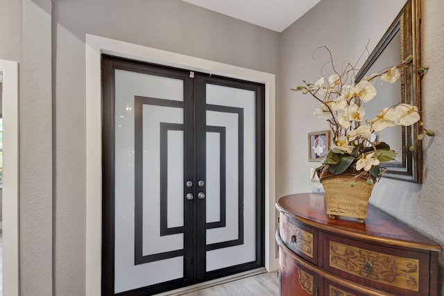 entrance foyer with light wood-type flooring and french doors