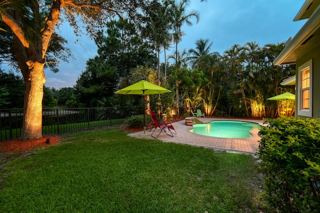 view of swimming pool featuring a patio area and a lawn