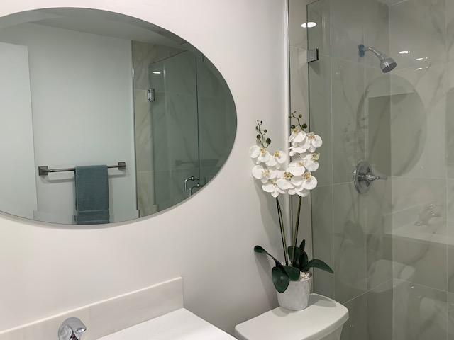 bathroom with vanity, an enclosed shower, and toilet