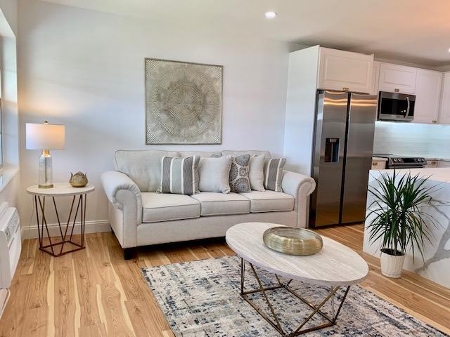 living room with light hardwood / wood-style flooring