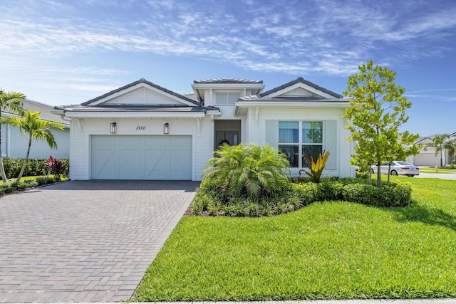 view of front of home with a garage and a front lawn