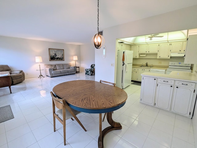 dining space with light tile patterned floors, a ceiling fan, visible vents, and baseboards