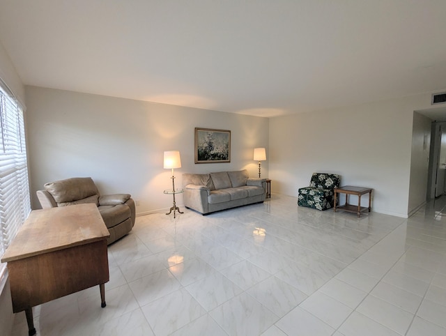 living area with visible vents and baseboards