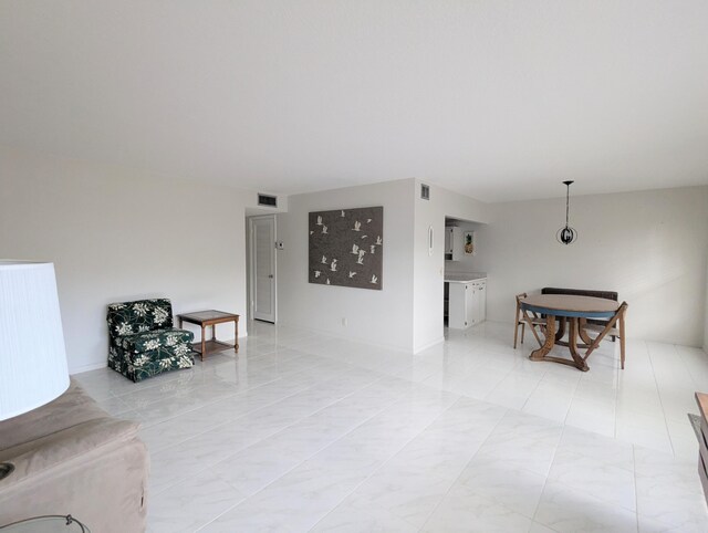 kitchen with kitchen peninsula, light tile patterned flooring, white appliances, and sink