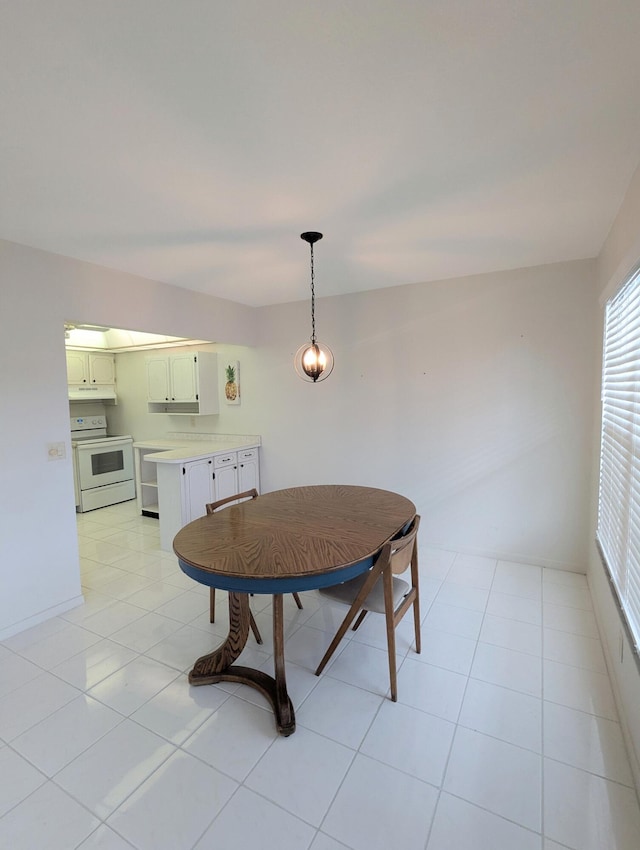 dining area with baseboards and light tile patterned flooring