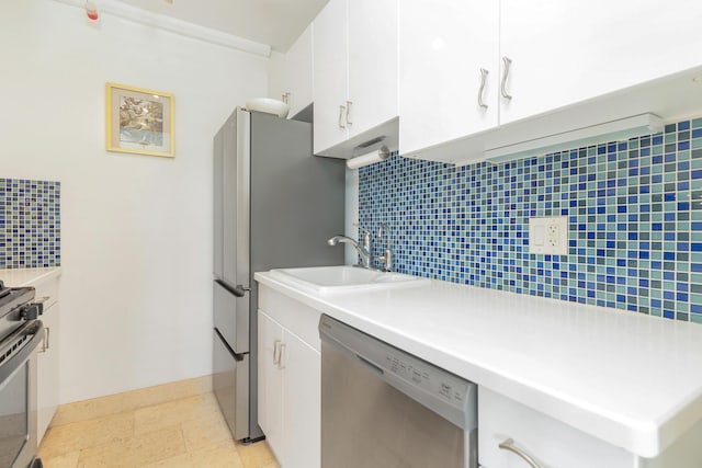 kitchen with backsplash, sink, white cabinets, and stainless steel appliances