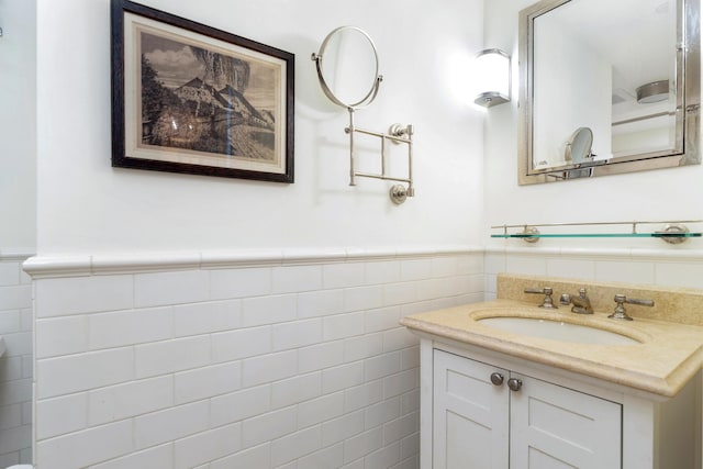 bathroom featuring vanity and tile walls