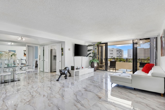 living room with floor to ceiling windows, a notable chandelier, a textured ceiling, and light tile floors