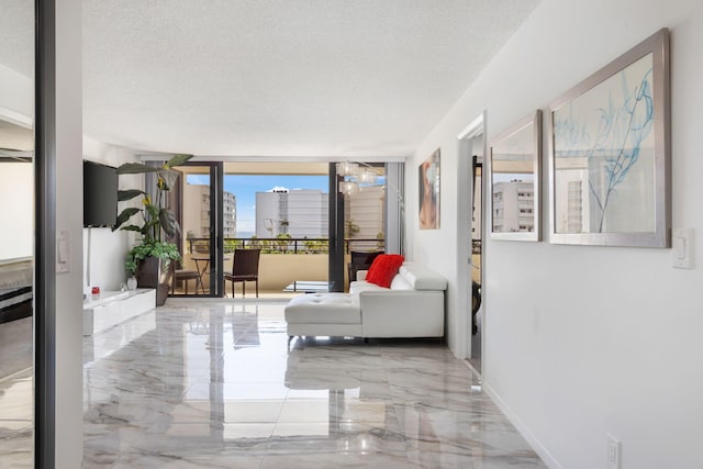 living room with floor to ceiling windows, a textured ceiling, and light tile floors