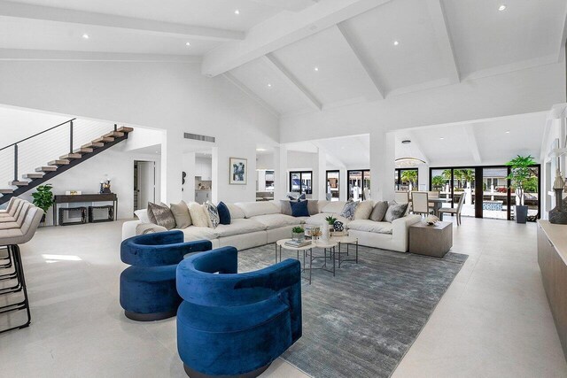 living room with high vaulted ceiling and beam ceiling