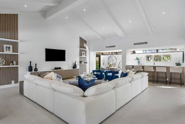 tiled living room with beam ceiling and high vaulted ceiling