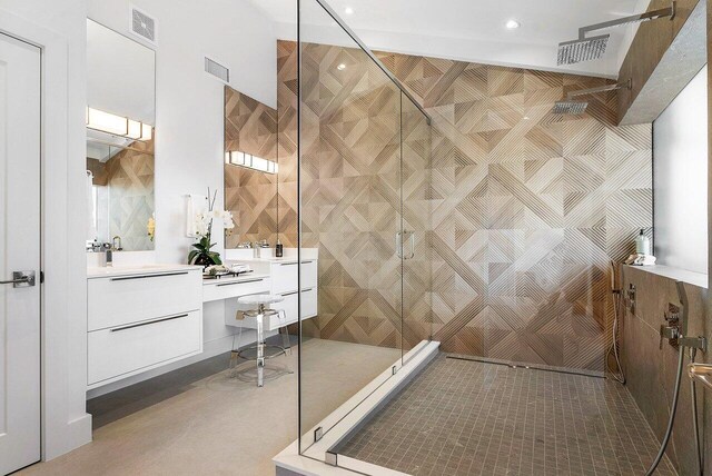 bathroom featuring tile floors, a shower with shower door, vanity, and tile walls