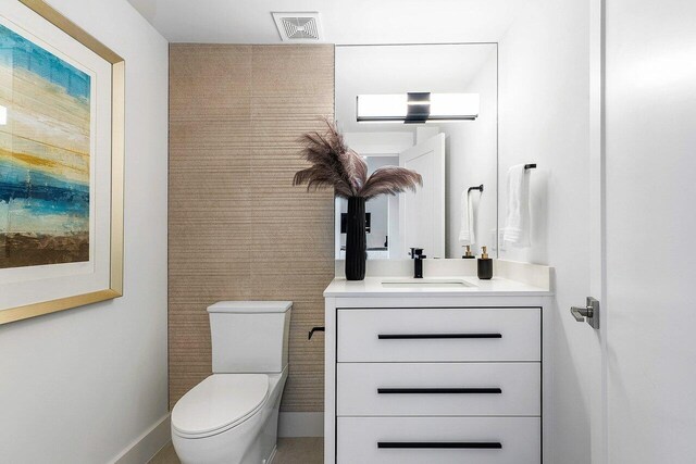 bathroom featuring oversized vanity and toilet