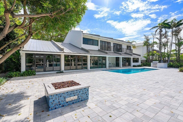 view of pool featuring a fire pit and a patio area