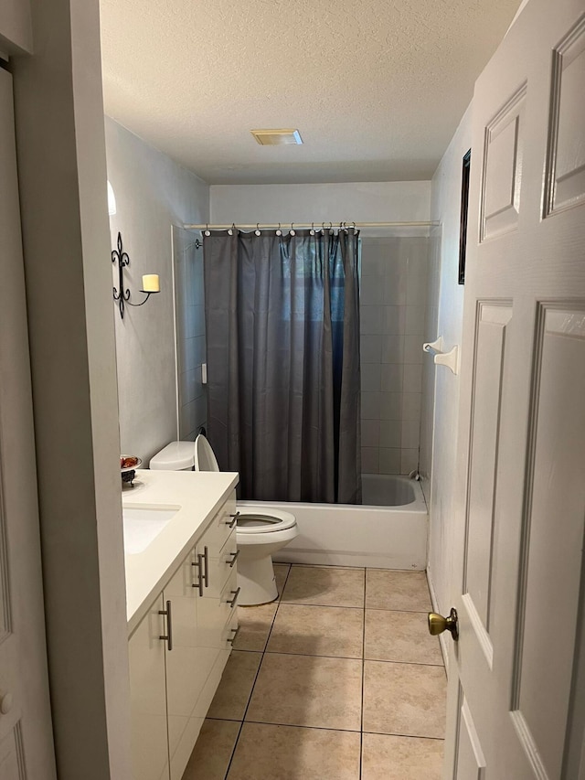 full bathroom with toilet, tile flooring, vanity, a textured ceiling, and shower / tub combo with curtain