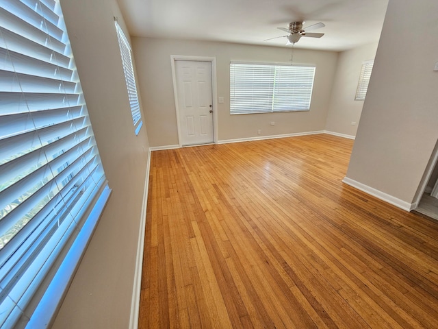 empty room featuring ceiling fan and light hardwood / wood-style flooring